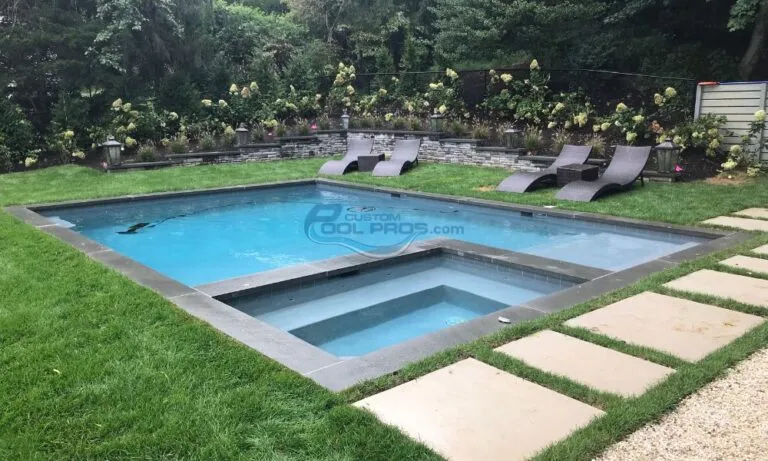 inground rectangular pool with black lunge chairs, best pool companies in nj