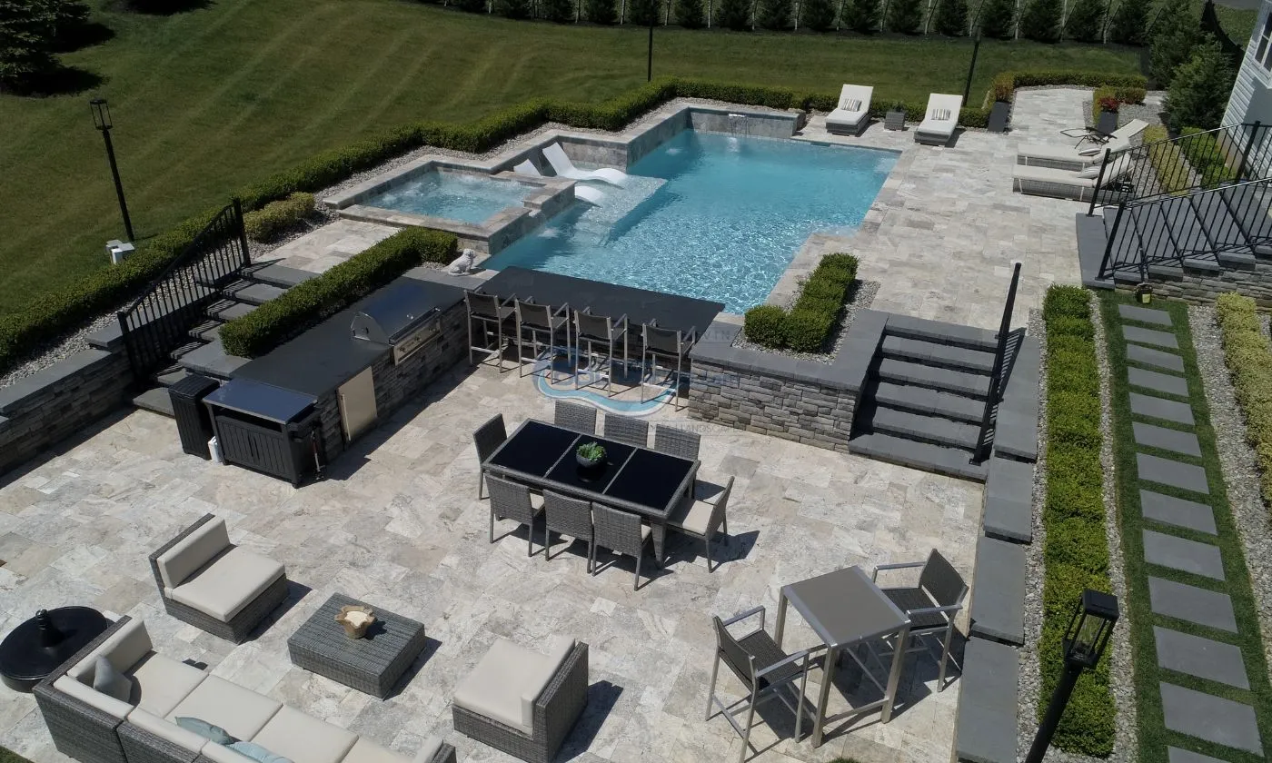 inground pool build with custom shape and full patio backyard with patio furniture, grill area and swim up bar, inground pool