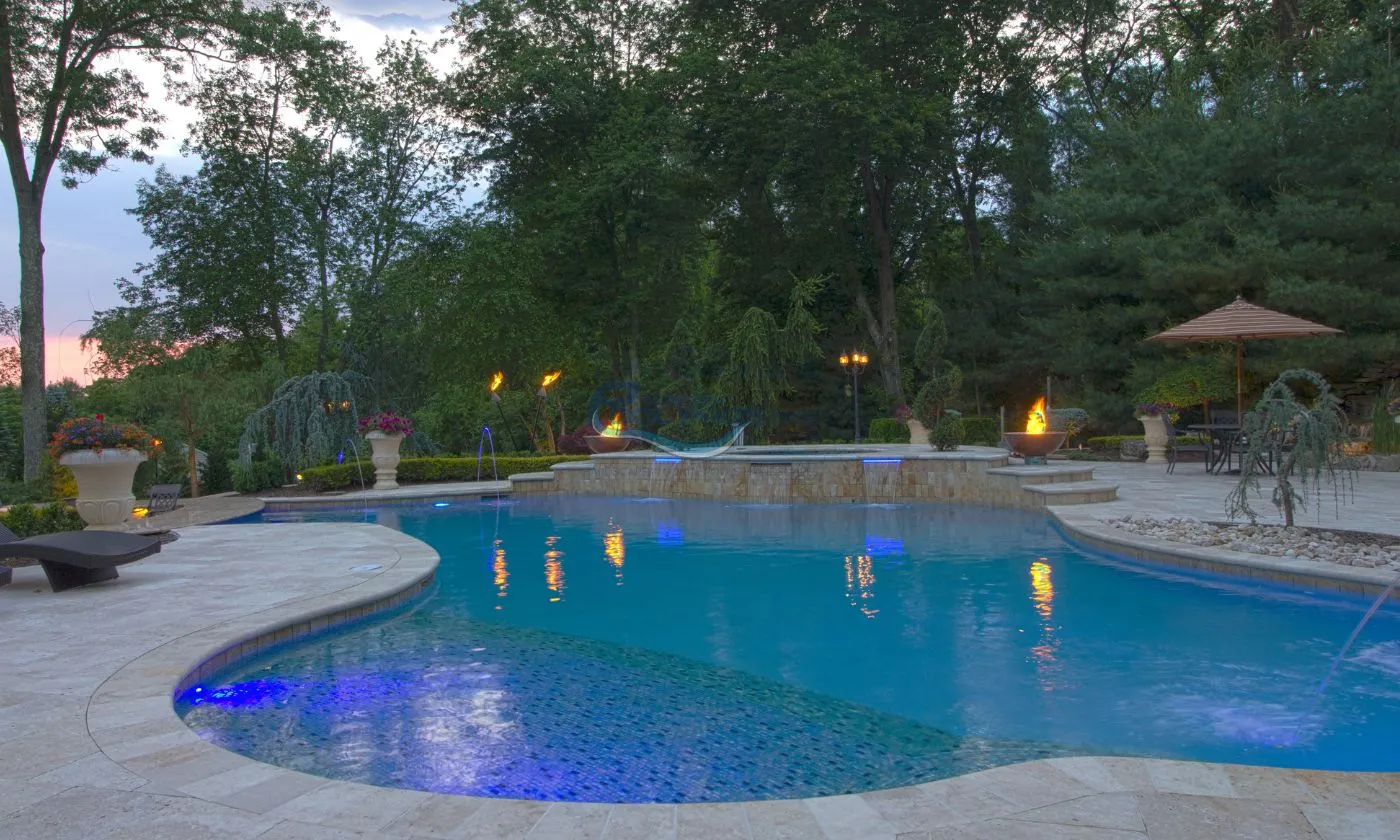 custom freeform pool build with spa and waterfalls, swim up bar, pool deck lounge area, inground pool