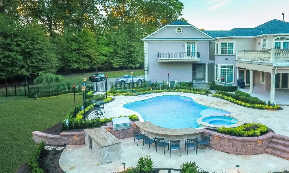 luxury gunite pool installation with swim-up bar, pool patio, landscaping in Allenhurst NJ