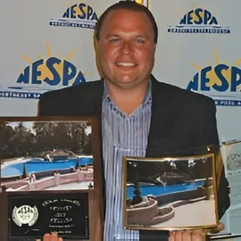 Custom pool builder serving North Jersey, standing beside NESPA pool awards
